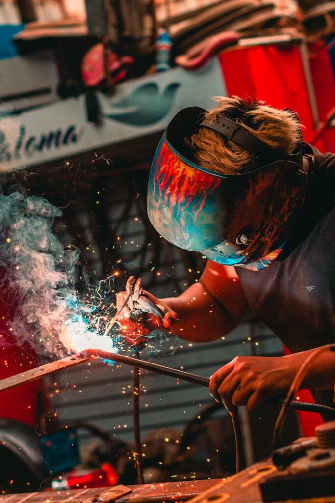 Quizzes Close-up of a welder using safety gear and creating sparks in an industrial setting.